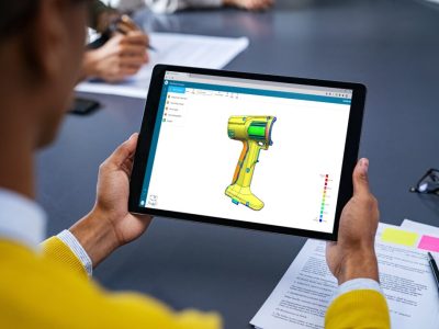 Close up of young man using digital tablet to study marketing strategy. African businessman studying business planning. Rear view of student holding tablet in hands and analyze business material on screen.